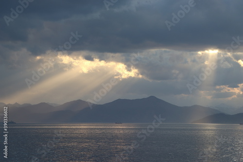 beautiful landscape. the sun hid the clouds. the rays of the sun fall on the water surface