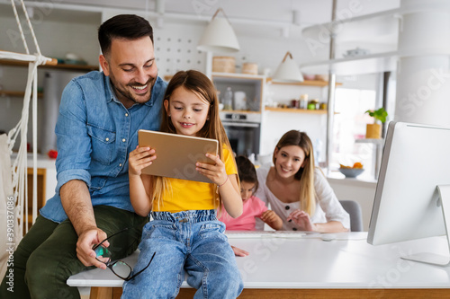 Happy family spending time at home and using digital, technology devices. photo