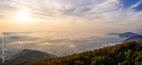 Aerial shoot of Graz city covered if fog on autumn morning during sunraise.