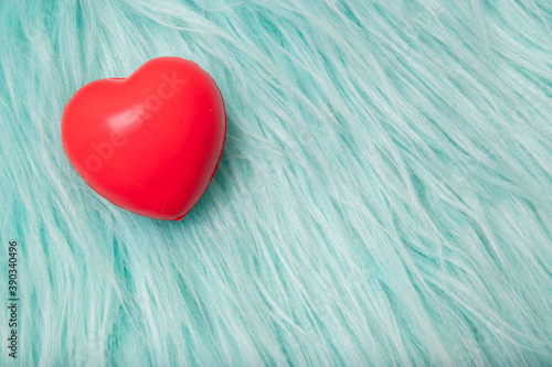 The red Heart shapes on abstract turquoise fur photo