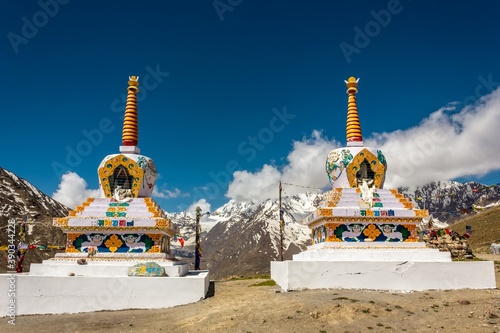 Buddhist stupas at the top of the high pass of Kunzum La with a backdrop of Himalayan mountains.