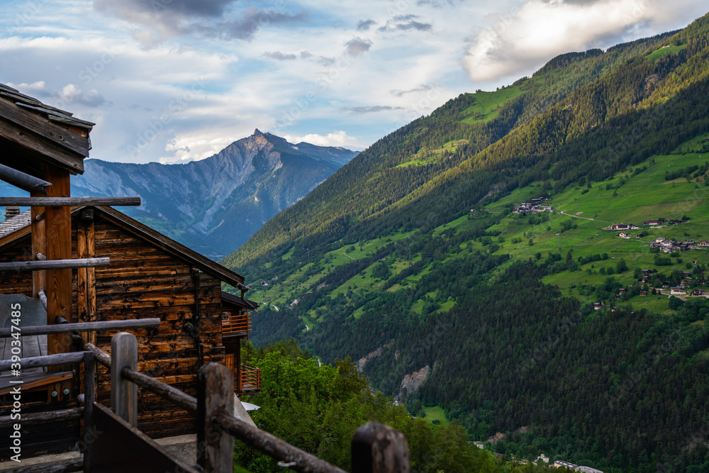 Scenic view of beautiful Swiss Alps mountains. Canton du Valais, Switzerland. Picturesque Alpine village in background. Switzerland in summer. Alpine landscape