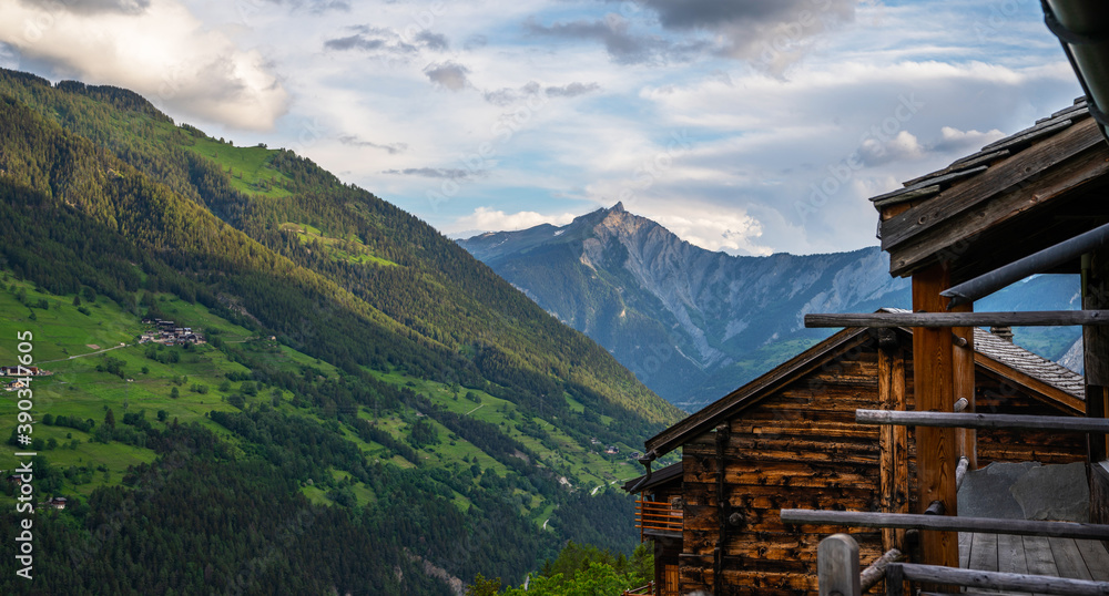 Scenic view of beautiful Swiss Alps mountains. Canton du Valais, Switzerland. Picturesque Alpine village in background. Switzerland in summer. Alpine landscape