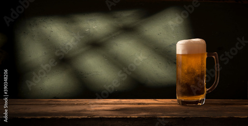 Glass beer on wood background with copyspace