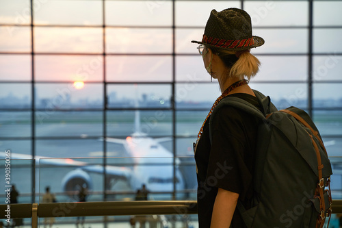 Photography asian woman female air traveler looking at sunrise in airport terminal building