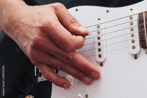 Hand playing electric guitar. electric bass