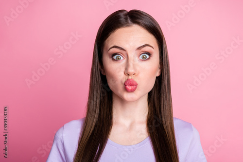 Closeup photo of attractive charming cute appearance lady long straight hairdo sending air kisses boyfriend lovely wear casual purple violet t-shirt isolated pink pastel color background