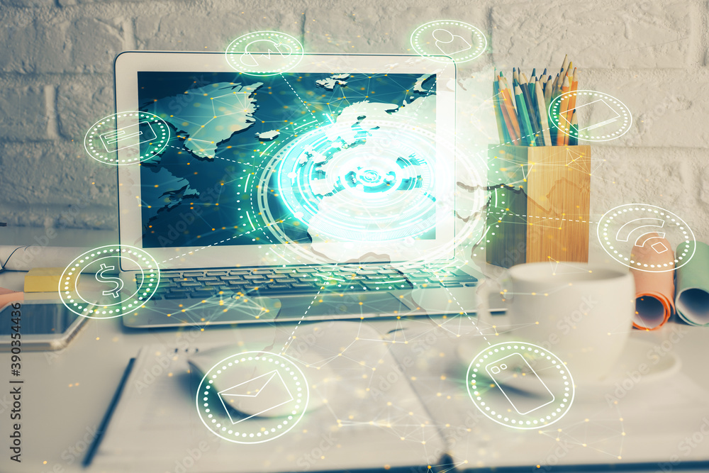 Computer on desktop with social network hologram. Multi exposure. Concept of international people connections. Computer on desktop with social network hologram. Multi exposure. Concept of international people connections.