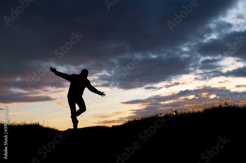 Wallpaper Mural silhouette of a man standing on one leg and trying to balance Torontodigital.ca