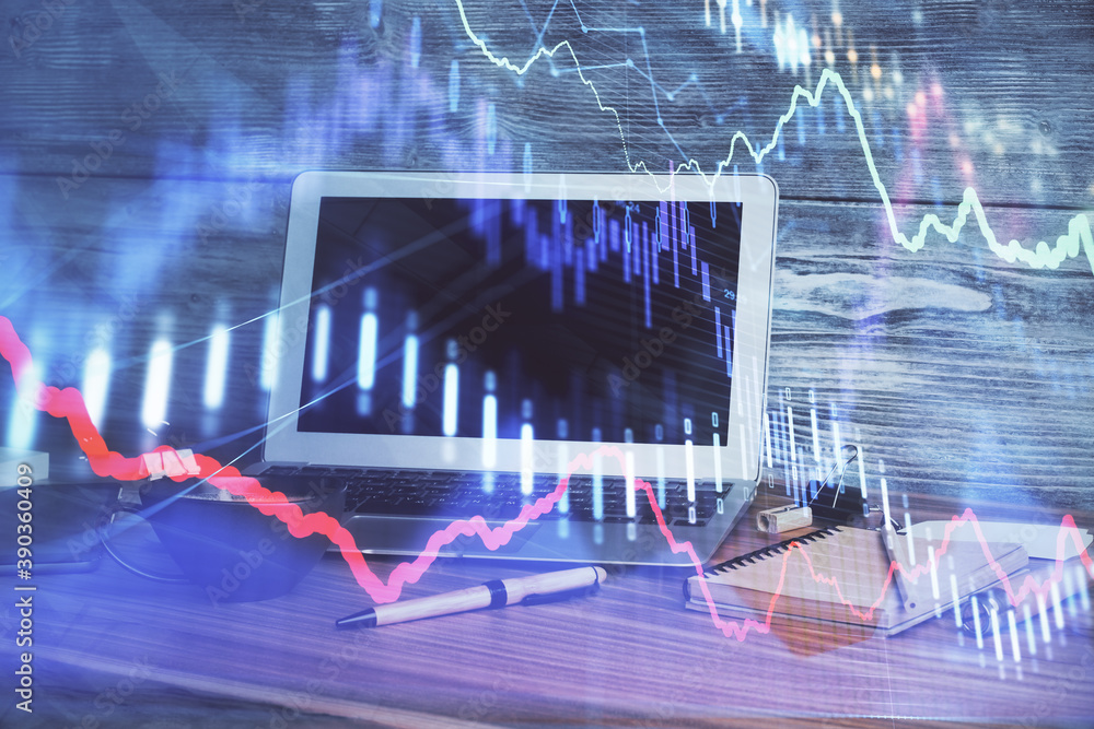 Financial chart drawing and table with computer on background. Double exposure. Concept of international markets. Financial chart drawing and table with computer on background. Double exposure. Concept of international markets.