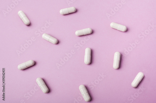 Pills on a pink background. Biologically active additives.
