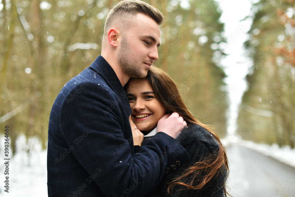 Fototapeta premium hugs of a couple in love. Winter love story