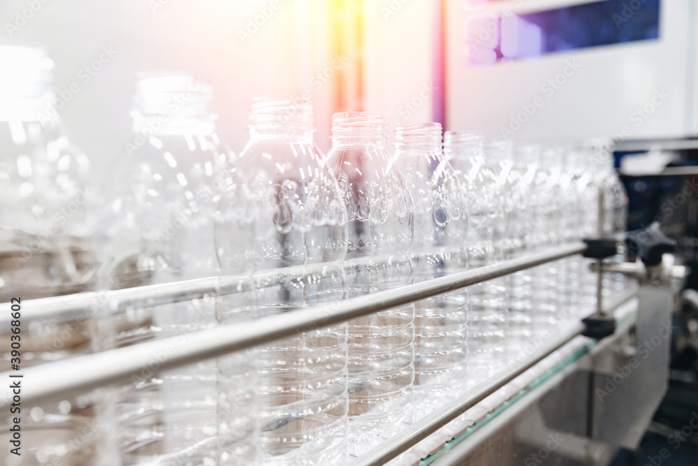 PET plastic bottles on a food automated line, milk and yoghurt bottling industry in dairy factory PET plastic bottles on a food automated line, milk and yoghurt bottling industry in dairy factory