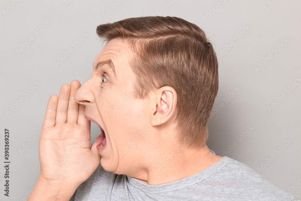Portrait of man shouting in full voice and calling someone Portrait of man shouting in full voice and calling someone