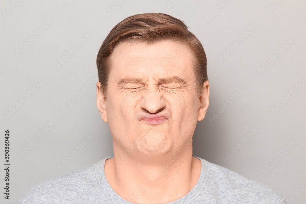 Portrait of funny disgruntled man grimacing from grudge and disgust Portrait of funny disgruntled man grimacing from grudge and disgust