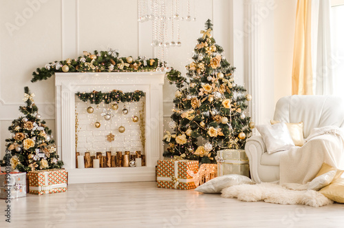 New Year decorated white interior - bright room with Christmas decoration - fir-tree, white pedestal, white armchair and hide rug - holiday room interior