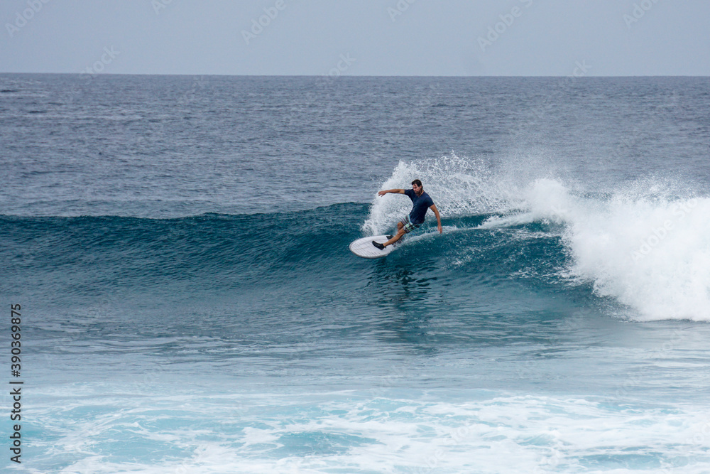 Surfer on perfect blue aquamarine wave, empty line up, perfect for surfing, clean water, Indian Ocean Surfer on perfect blue aquamarine wave, empty line up, perfect for surfing, clean water, Indian Ocean