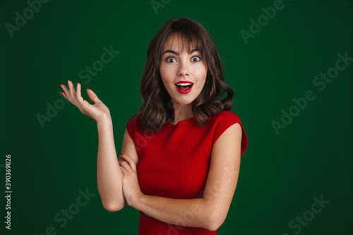 Beautiful happy brunette girl expressing surprise at camera