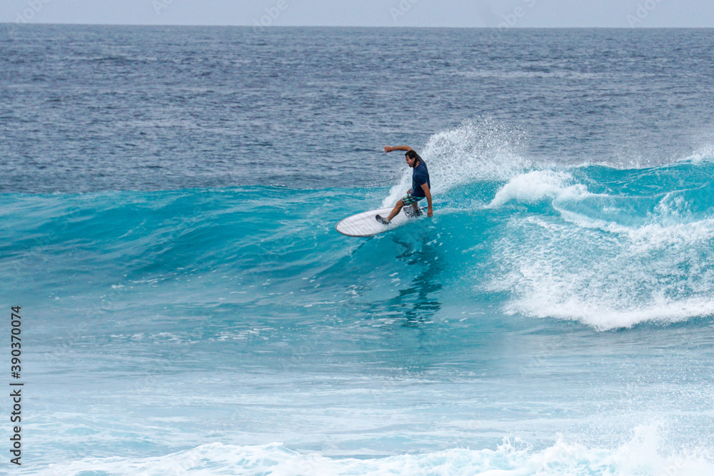 Surfer on perfect blue aquamarine wave, empty line up, perfect for surfing, clean water, Indian Ocean Surfer on perfect blue aquamarine wave, empty line up, perfect for surfing, clean water, Indian Ocean