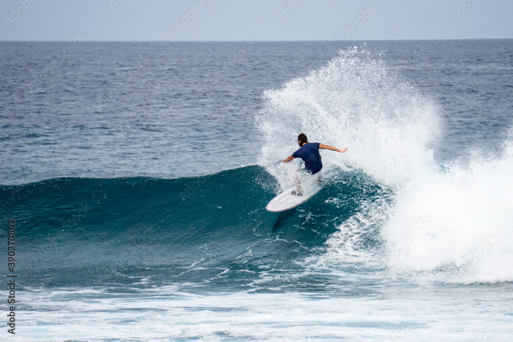 Surfer on perfect blue aquamarine wave, empty line up, perfect for surfing, clean water, Indian Ocean Surfer on perfect blue aquamarine wave, empty line up, perfect for surfing, clean water, Indian Ocean