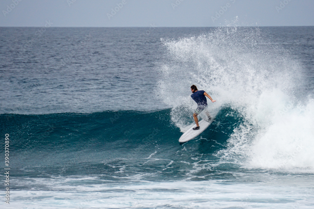 Surfer on perfect blue aquamarine wave, empty line up, perfect for surfing, clean water, Indian Ocean Surfer on perfect blue aquamarine wave, empty line up, perfect for surfing, clean water, Indian Ocean