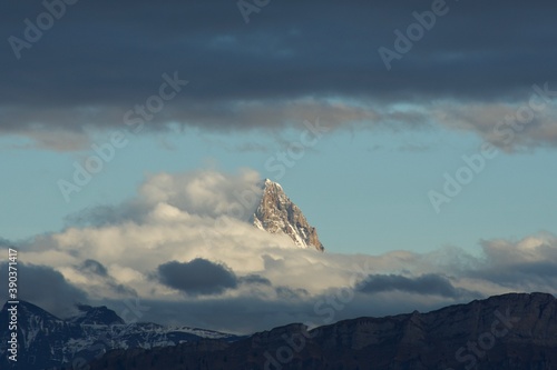 Glimpse of Mountain peak in dramatic cloudescape photo