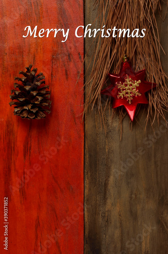 pine cone and star on wood written "merry christmas"