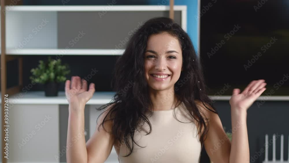 Happy pretty young woman doing online video conference call with friend at webcam indoors at home. Videocall and social media vlogging concept. Happy pretty young woman doing online video conference call with friend at webcam indoors at home. Videocall and social media vlogging concept.
