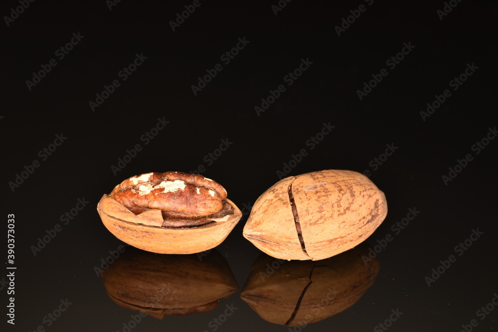 Several ripe unpeeled pecans, close-up, isolated on black. Several ripe unpeeled pecans, close-up, isolated on black.
