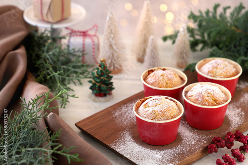 Christmas plain muffins with icing sugar on Christmas decoration background. プレーンマフィン クリスマス