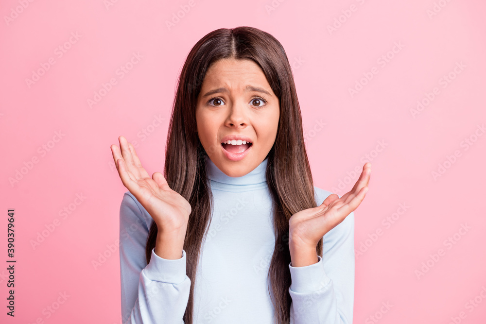 Photo of unhappy mad little girl hands sides disagree open mouth isolated on pastel pink color background Photo of unhappy mad little girl hands sides disagree open mouth isolated on pastel pink color background