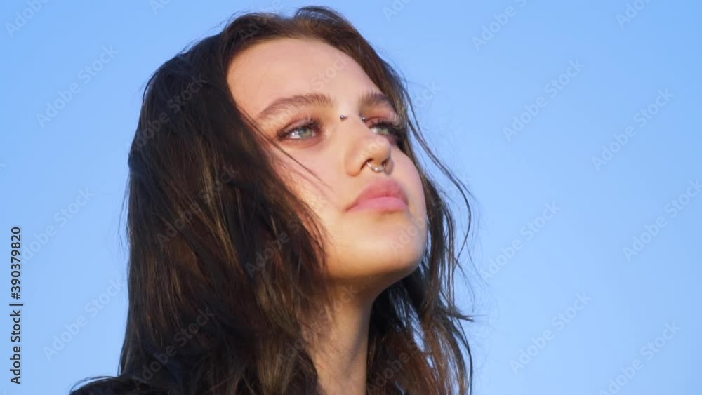 Portrait of a Gorgeous Dark Haired Teenage Girl with Piercings Looking Up To The Blue Sky With Hope Pray Prayer Happy Young Teenager Enjoys Life Portrait of a Gorgeous Dark Haired Teenage Girl with Piercings Looking Up To The Blue Sky With Hope Pray Prayer Happy Young Teenager Enjoys Life
