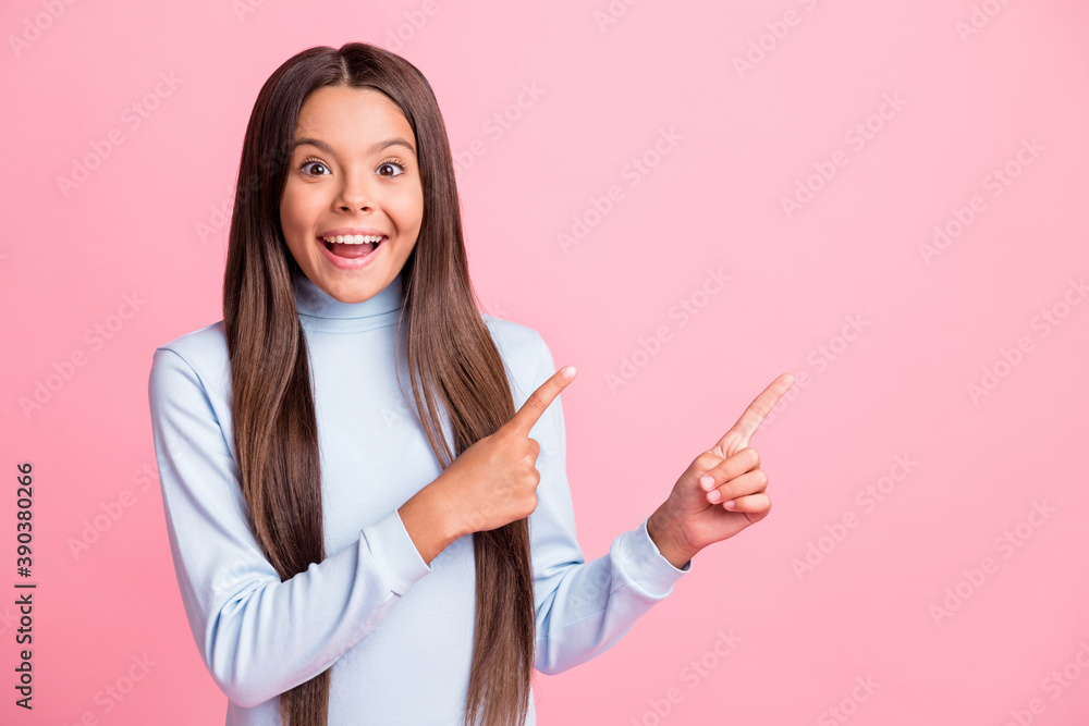 Photo of astonished pupil indicate hand open mouth show tips promotion blue turtleneck isolated on pink color background Photo of astonished pupil indicate hand open mouth show tips promotion blue turtleneck isolated on pink color background