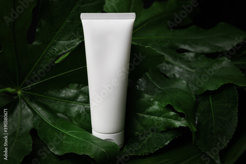 Canvas Print white blank hand cream tube with green leaves. organic cosmetics