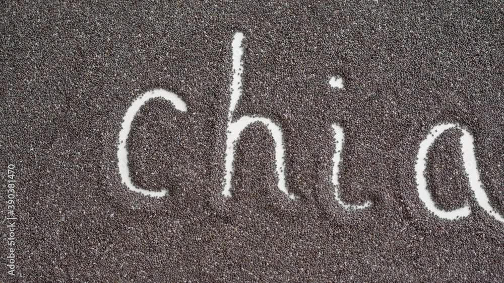 Lettering Chia written in chia seeds spread on a flat surface Lettering Chia written in chia seeds spread on a flat surface