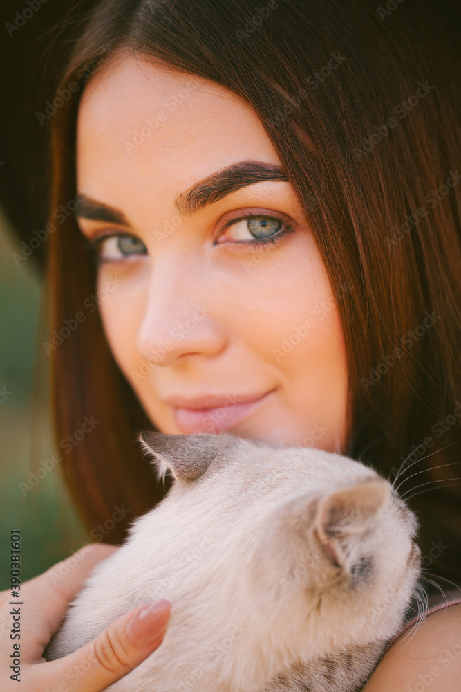 Girl in dress and hat holding a kitten Girl in dress and hat holding a kitten