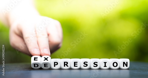 Hand turns dice and changes the word "depression" to "expression".