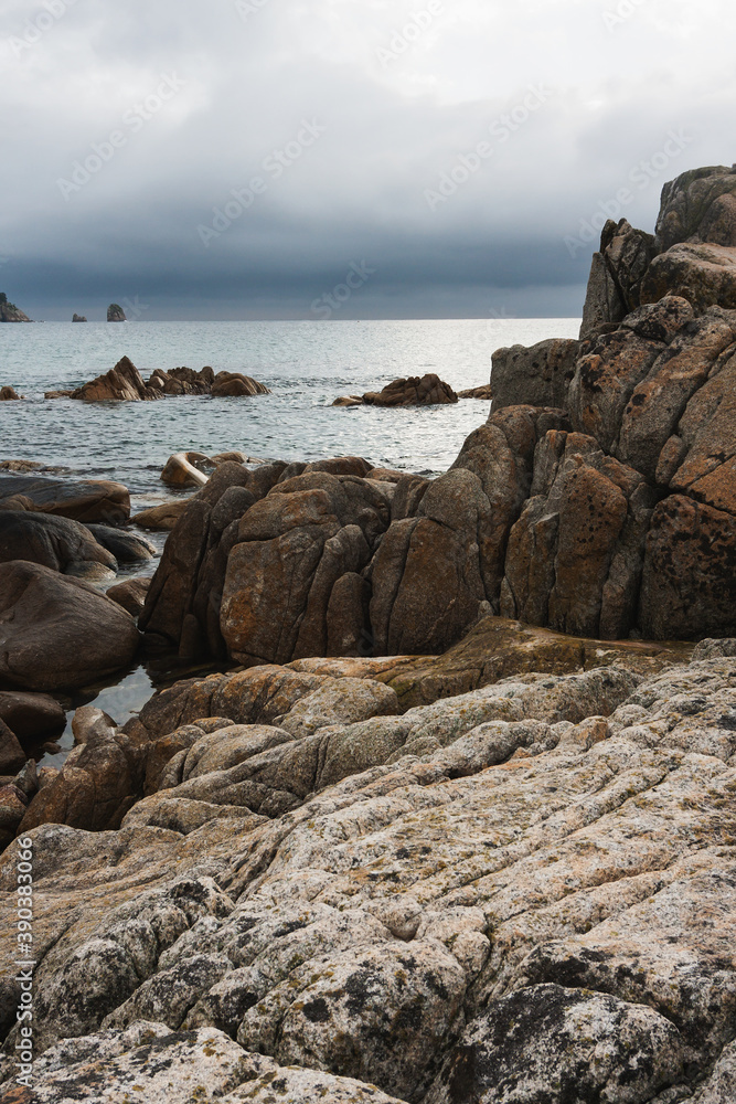 Cloudy summer day on the sea with a rocky shore coastline of the Bay.