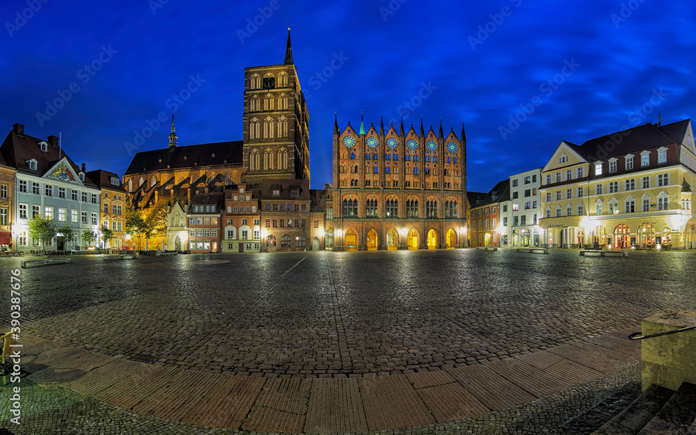 Stralsund, Germany. Night panorama of Old Market square with Nicholas' Church and City Hall in brick gothic style.