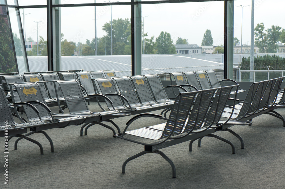 Rows of empty lounge chairs at the airport.