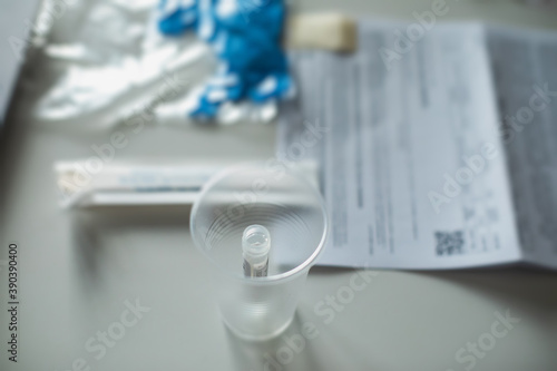 Process of coronavirus testing examination at home, COVID-19 swab collection kit, test tube for taking OP NP patient specimen sample, testing carried out, patient receiving a corona test