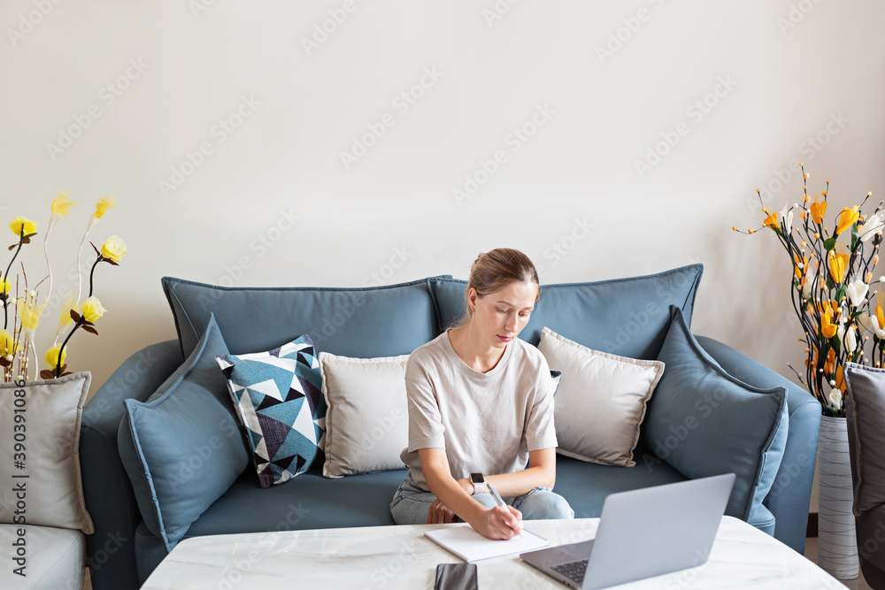 Young beautiful woman stylish wearing on gray textile sofa at home. Attractive slim female in domestic situation, staying home, resting on couch in her apartment. Background, copy space, close up. Young beautiful woman stylish wearing on gray textile sofa at home. Attractive slim female in domestic situation, staying home, resting on couch in her apartment. Background, copy space, close up.