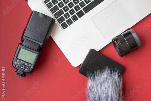 Camera gear red background top view copy space
