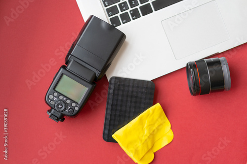 Camera gear red background top view copy space