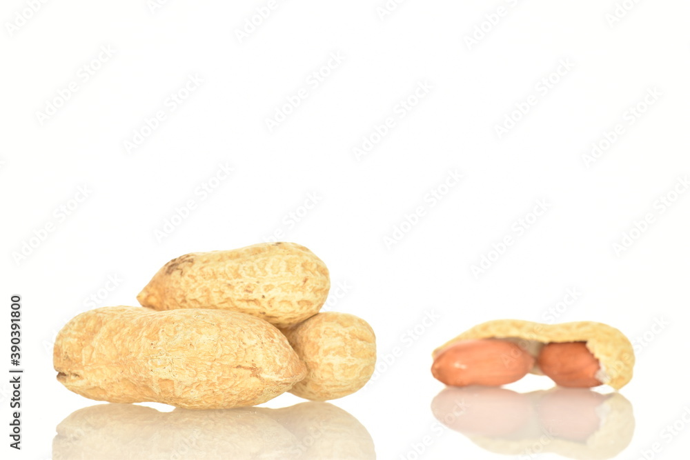 Obraz premium Unpeeled organic peanuts, close-up, on a white background.