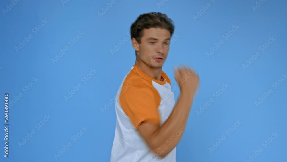 cheerful man in t-shirt dancing isolated on blue cheerful man in t-shirt dancing isolated on blue