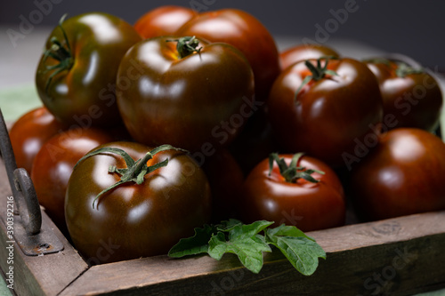 Fresh ripe sweet reddish brown and green kumato tomatoes photo
