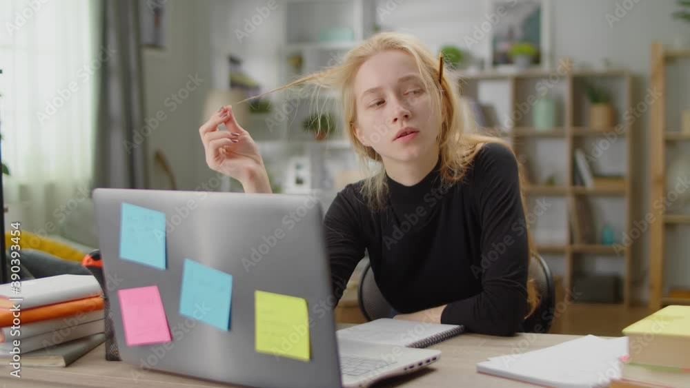 Young woman thinking about solving a problem while studying at home in living room Young woman thinking about solving a problem while studying at home in living room