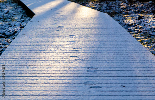 Footprints on the snow on a gangway