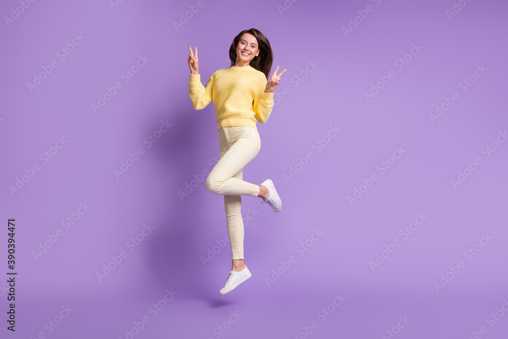 Full length photo portrait of girl jumping up showing two v-signs isolated on vivid violet colored background